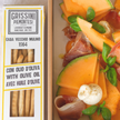 Grissini Piemontesi with a dish of melon, prosciutto, and olives.