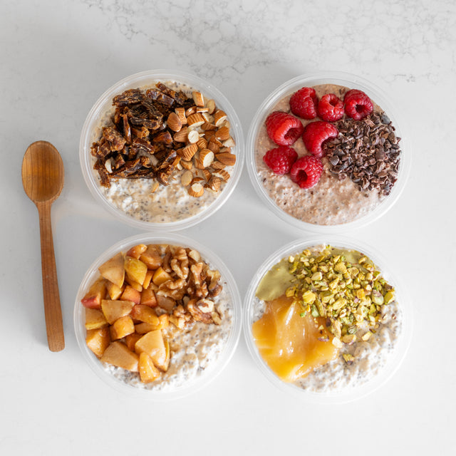Four bowls of oatmeal with various toppings