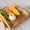 Plated dish with prosciutto, melon, and mozzarella