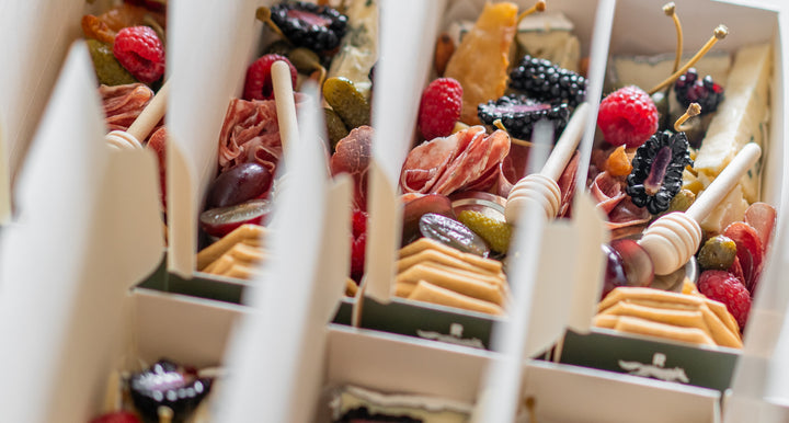 Assorted meats, cheeses, and fruits.